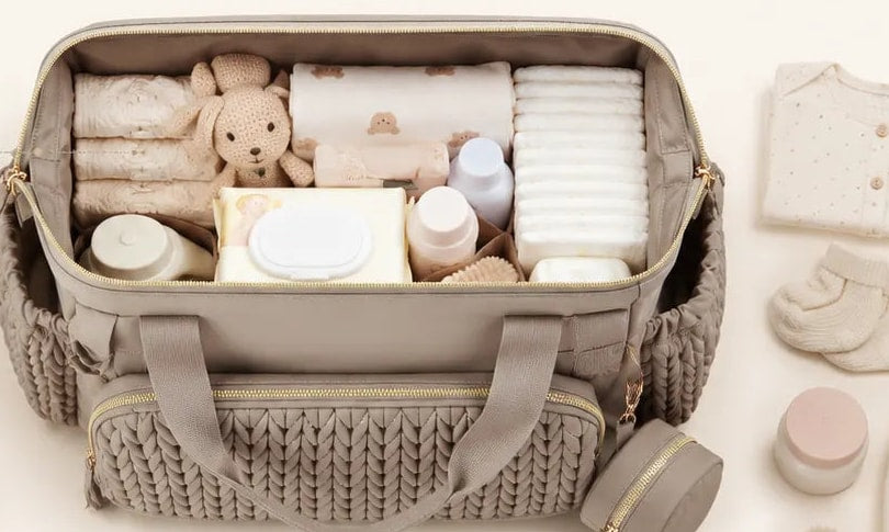 Large compartment of the Securidou hospital bag, open and filled with baby things