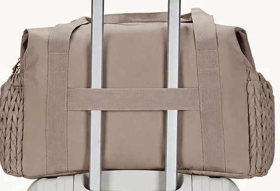 Rear sleeve of the Securidou hospital bag slipped over the handle of a suitcase