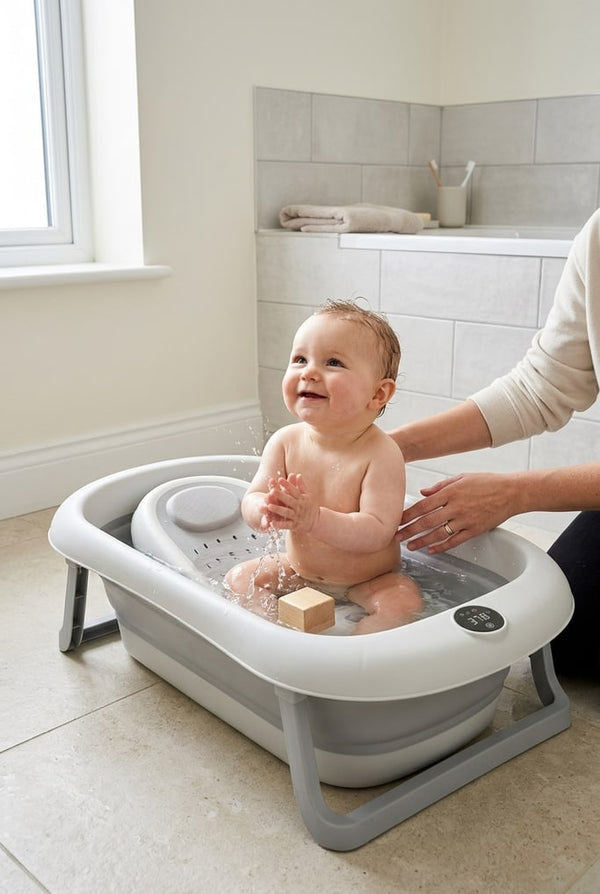 Baby sitting up and playing in the Securidou foldable bath, their parent beside them