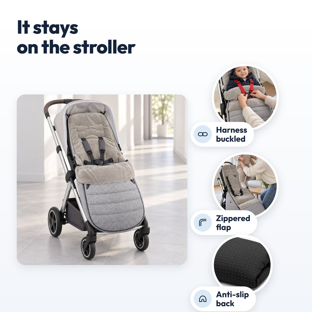 Securidou footmuff fitted on a stroller: harness buckled, zipped flap, grip dots on the back