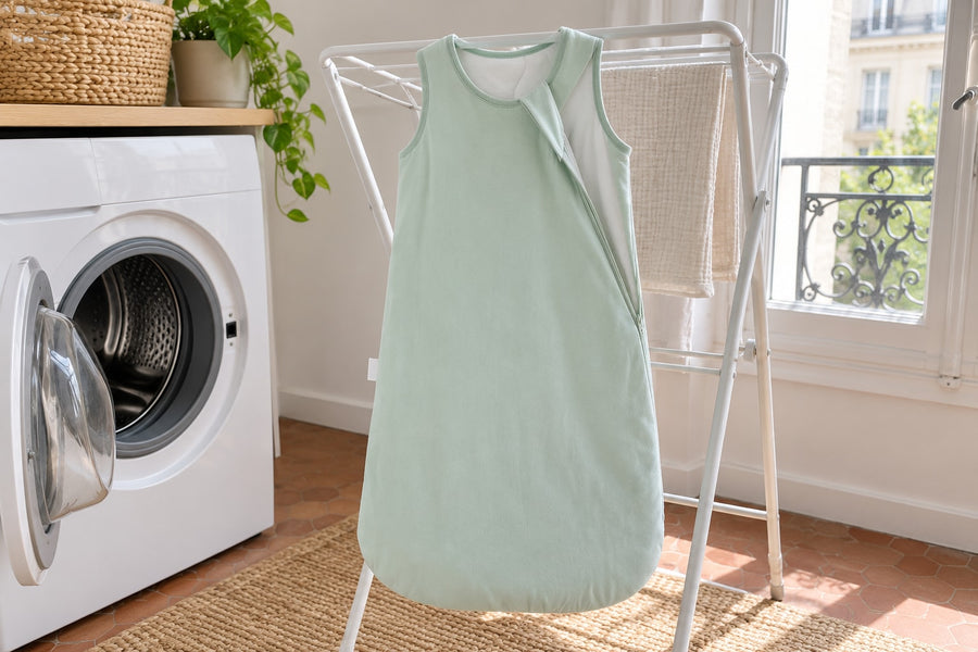 Sage green Securidou sleep sack drying on a rack after a machine wash