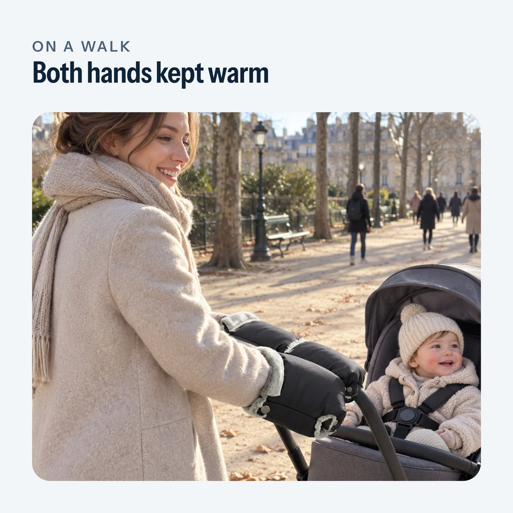 Parent on a winter walk, both hands in the black mittens fastened to the stroller handlebar