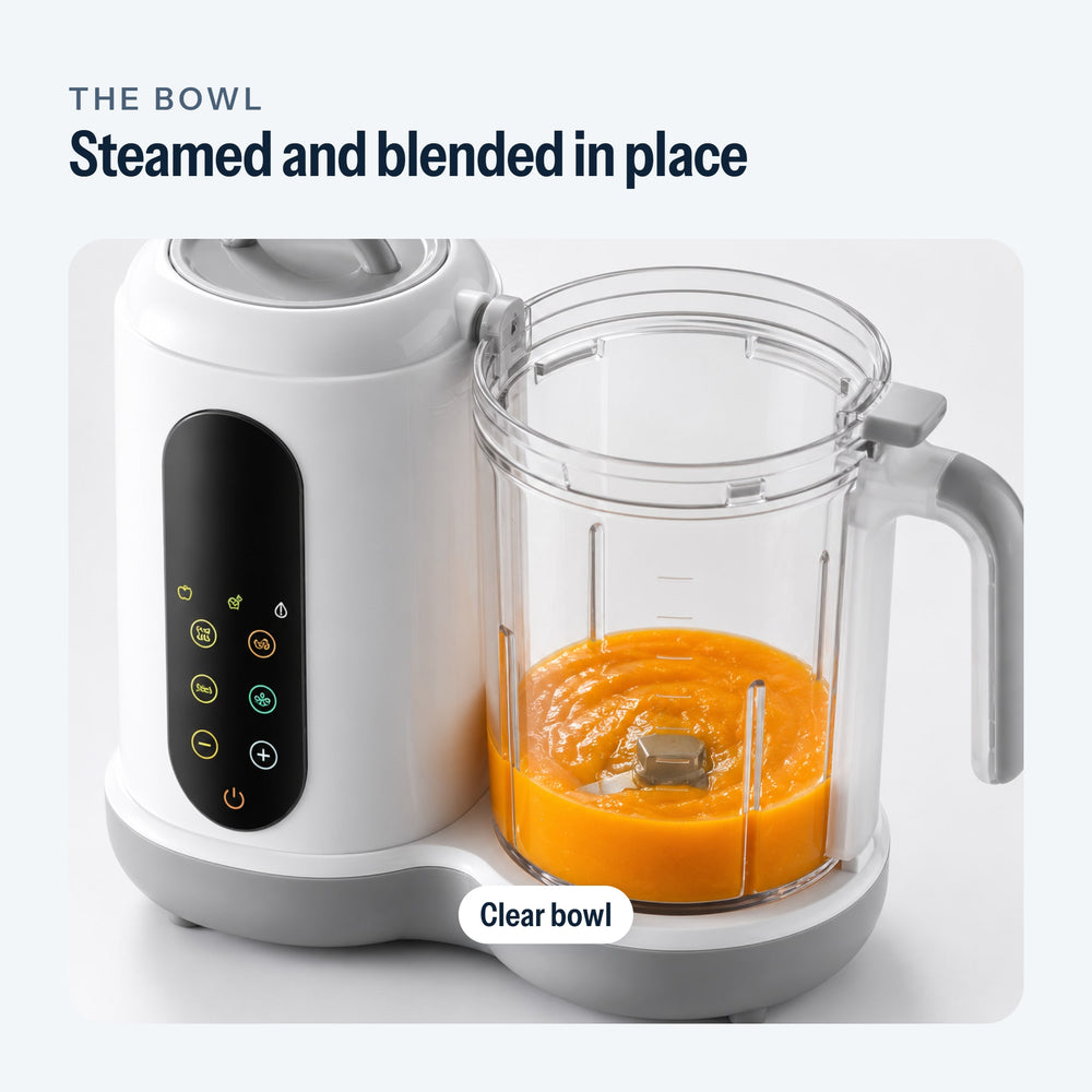 Clear bowl of the baby food maker filled with puree, blade visible at the bottom