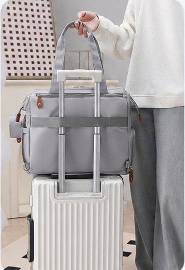 Securidou diaper bag attached to a suitcase handle