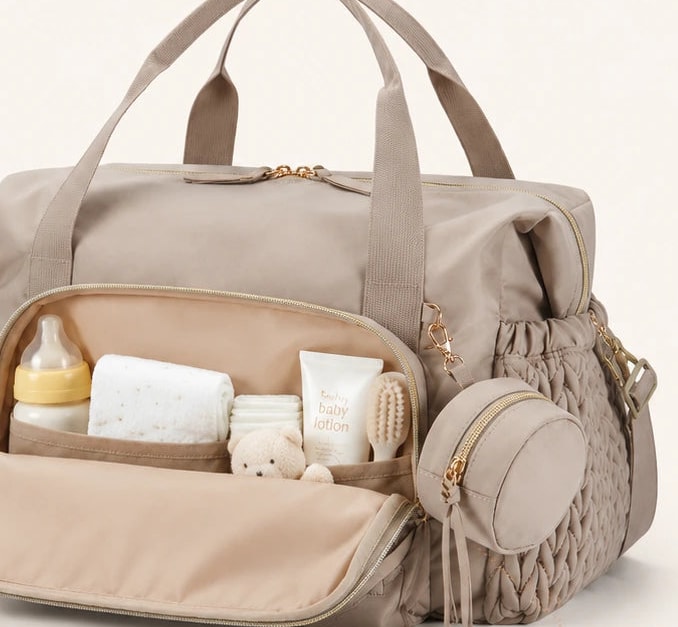 Large front pocket of the Securidou hospital bag, open, with its soother pouch