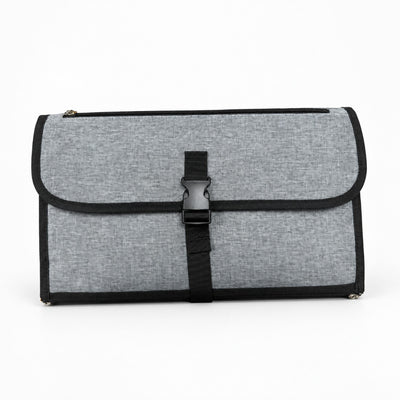Securidou portable changing pad in heather gray, folded into a clutch, on a white background